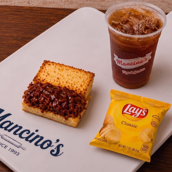 A parm grinder combo with chips and a Mancino's drink.